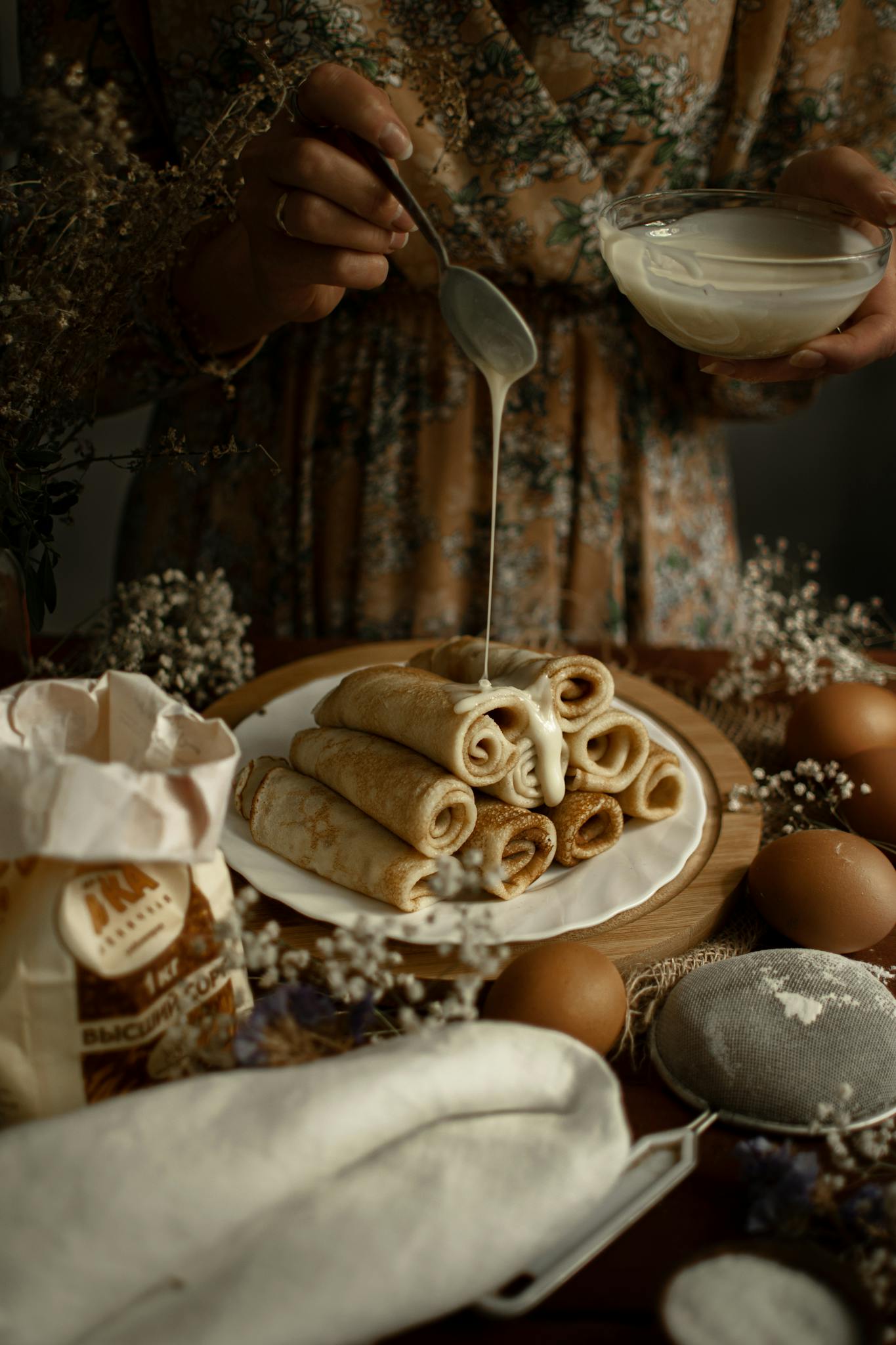 A plate of traditional Russian blini with a sweet sauce, perfect for dessert lovers.